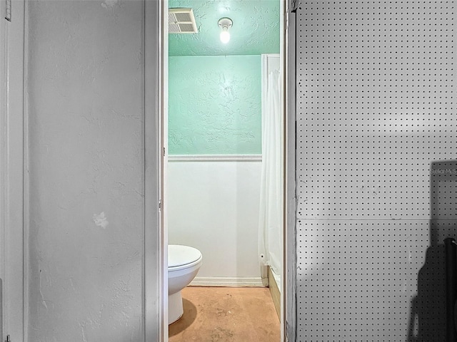 7206 Ashwood Dr, Port Richey, FL 34668 - full bathroom featuring a shower, toilet, concrete floors, and a textured wall