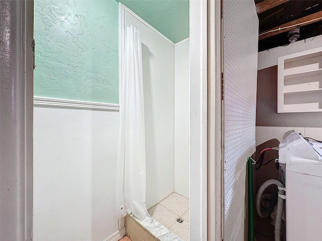 7206 Ashwood Dr, Port Richey, FL 34668 - bathroom featuring a shower with shower curtain, washer / clothes dryer, and tile patterned floors