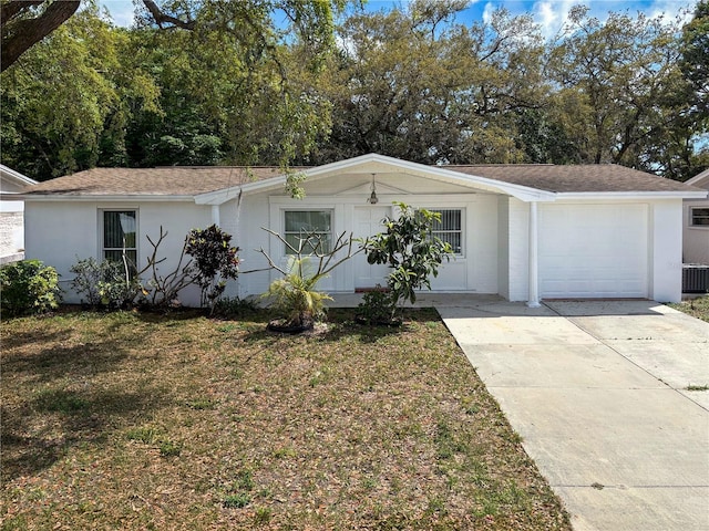 7206 Ashwood Dr, Port Richey, FL 34668 - view of front of property featuring a garage, concrete driveway, central air condition unit, and a front yard