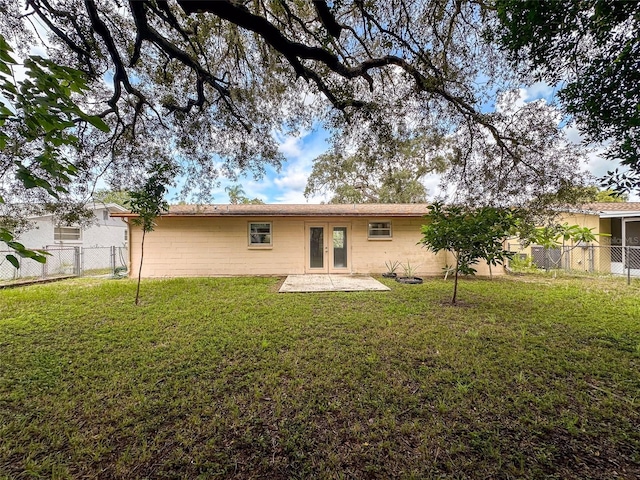 7206 Ashwood Dr, Port Richey, FL 34668 - rear view of property with french doors, a patio, and concrete block siding