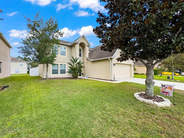 view of front facade featuring a front lawn and a garage