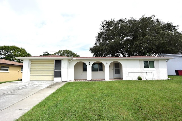 single story home with a garage and a front lawn