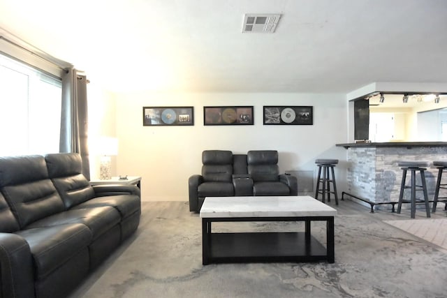 living room with indoor bar and track lighting