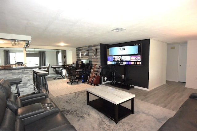 living room with indoor bar and hardwood / wood-style flooring