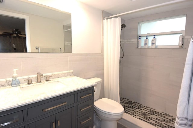 bathroom with decorative backsplash, walk in shower, vanity, and toilet