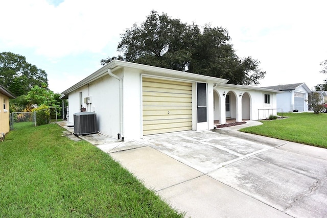 ranch-style home with a front lawn and central AC