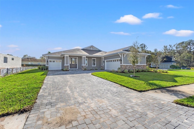 view of front facade featuring a front yard and a garage