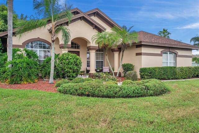 mediterranean / spanish-style home with a front lawn