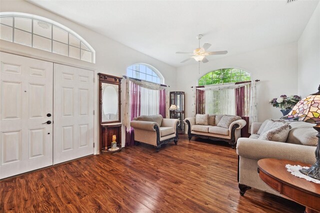 living room featuring ceiling fan and dark hardwood / wood-style floors