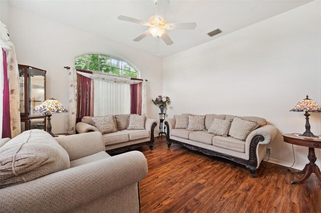 living room featuring ceiling fan and dark wood-type flooring