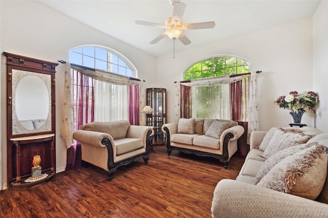 living room featuring a fireplace, dark hardwood / wood-style floors, ceiling fan, and plenty of natural light