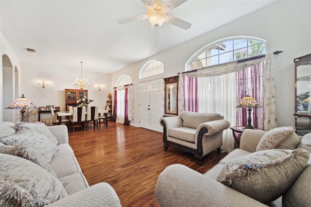 living room featuring ceiling fan with notable chandelier and dark hardwood / wood-style floors