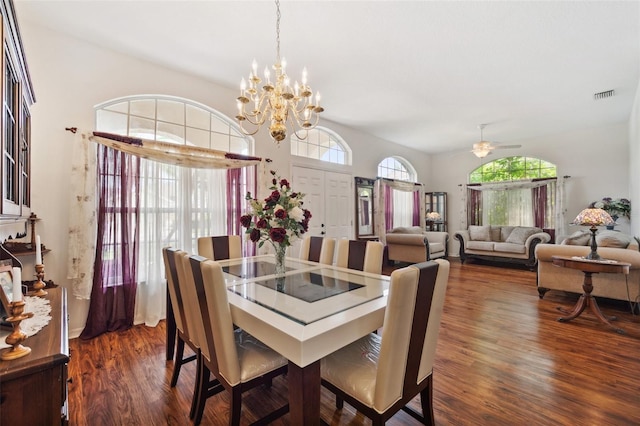 dining space featuring ceiling fan with notable chandelier, dark wood-type flooring, and a wealth of natural light