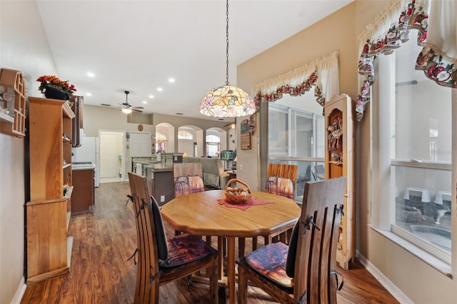 dining room featuring ceiling fan, dark hardwood / wood-style floors, and sink