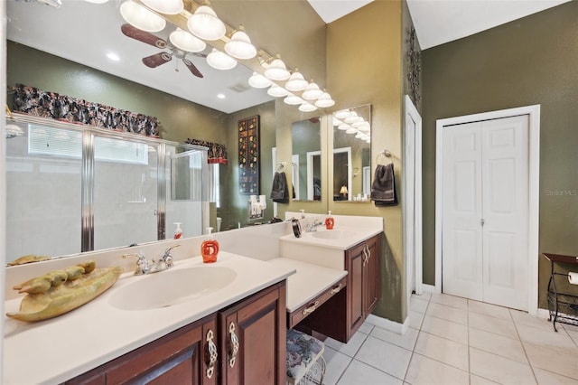 bathroom with tile patterned floors, ceiling fan, a shower with door, and vanity