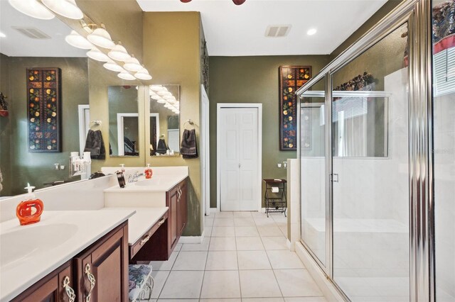 bathroom with tile patterned flooring, vanity, and an enclosed shower