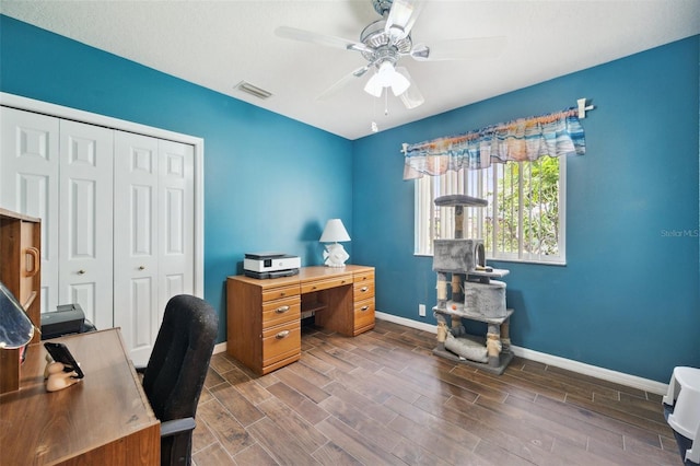 home office featuring ceiling fan and dark hardwood / wood-style flooring