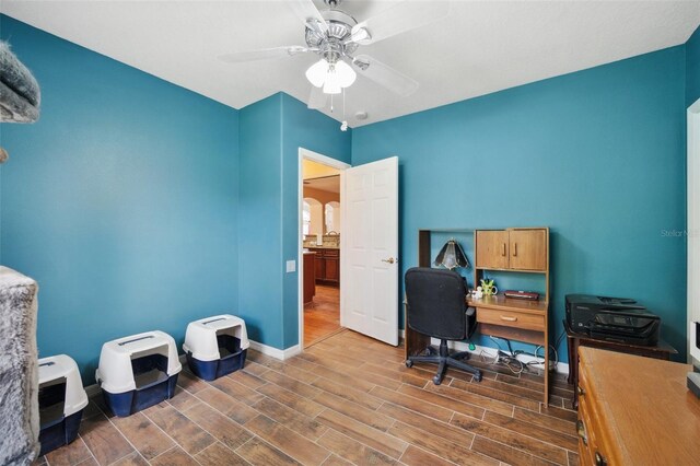 office space featuring ceiling fan and dark wood-type flooring