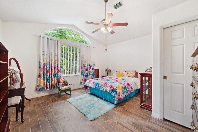 bedroom featuring vaulted ceiling, ceiling fan, and dark hardwood / wood-style floors