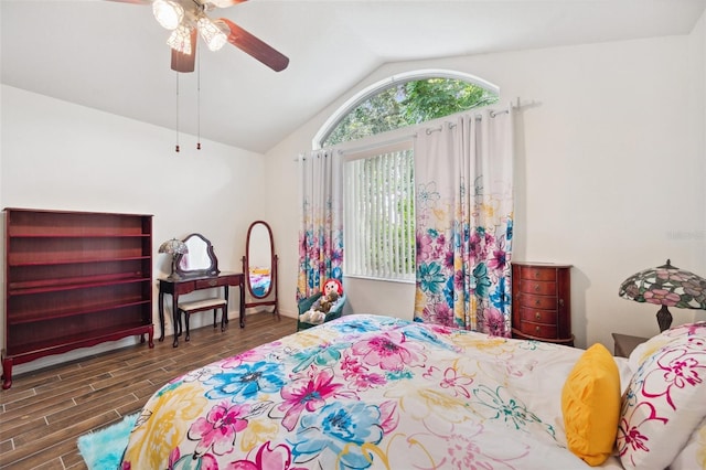 bedroom with vaulted ceiling, ceiling fan, and dark wood-type flooring