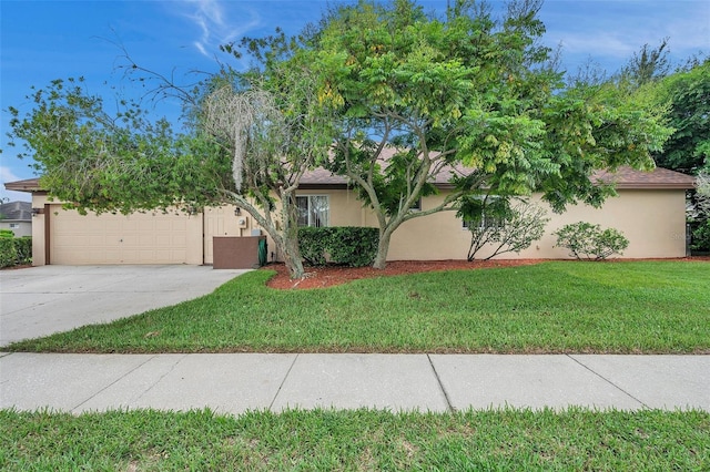 view of front of property with a garage and a front yard