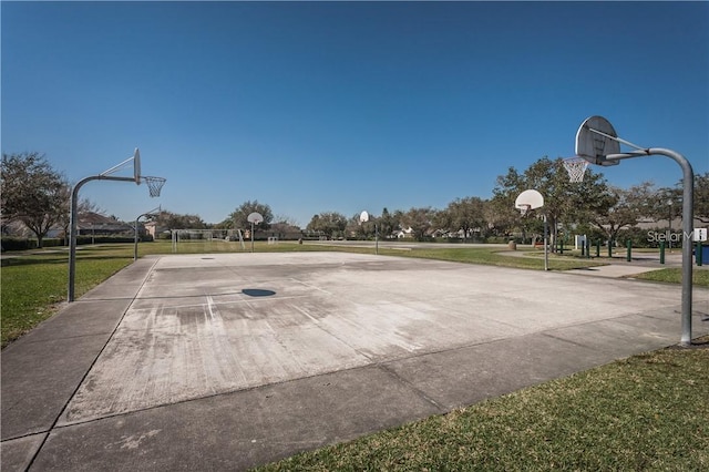 view of basketball court with a yard