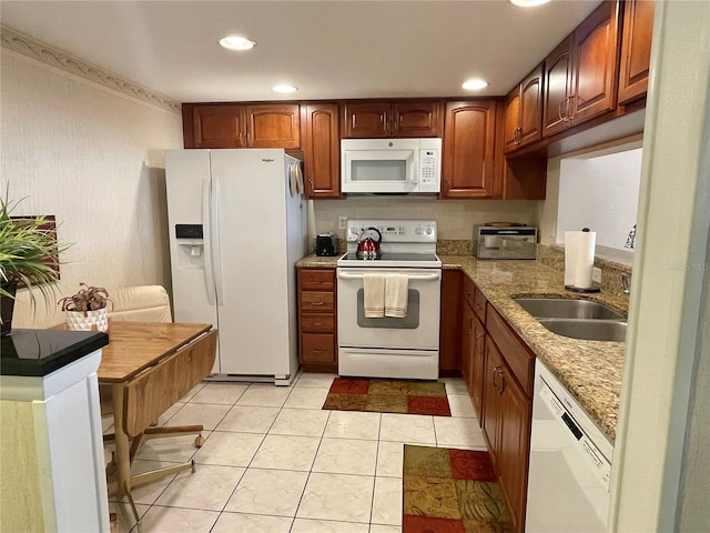 kitchen featuring light stone counters, light tile patterned flooring, sink, and white appliances