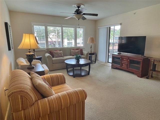 living room with carpet, ceiling fan, and plenty of natural light