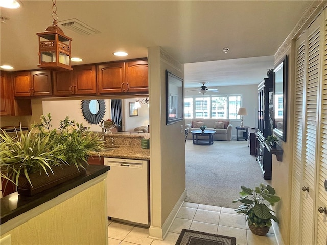 kitchen with light carpet, dishwasher, and ceiling fan