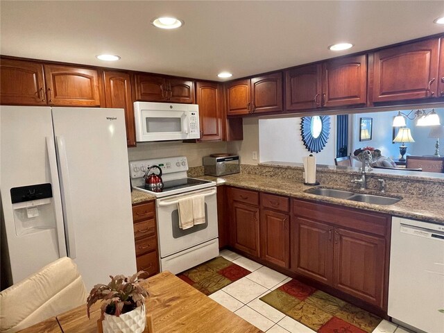 kitchen featuring white appliances, light tile patterned flooring, and sink