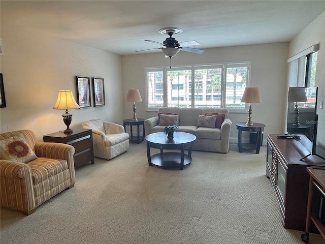 carpeted living room featuring ceiling fan and plenty of natural light