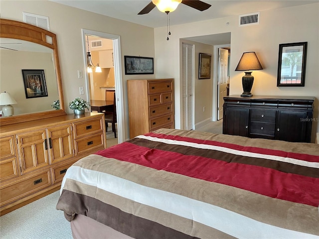 carpeted bedroom with connected bathroom and ceiling fan