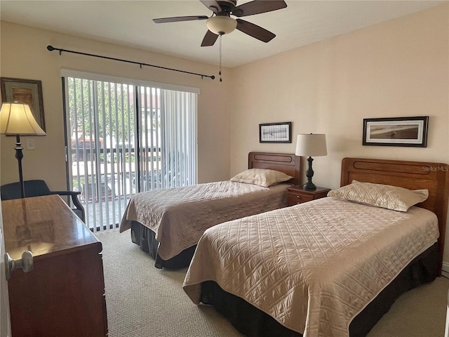 carpeted bedroom with ceiling fan and access to outside