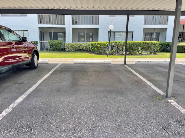 view of car parking with a lawn