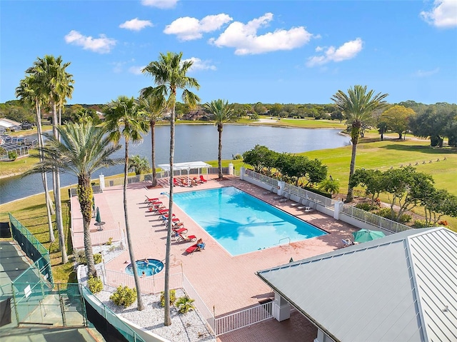 view of swimming pool with a water view and a patio area