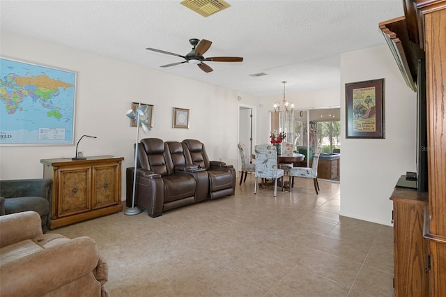 tiled living room featuring a textured ceiling and ceiling fan with notable chandelier