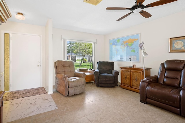 living area featuring ceiling fan and light tile patterned flooring