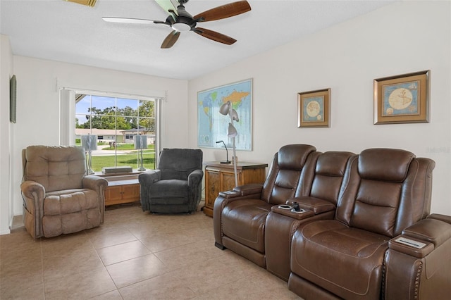 home theater with ceiling fan, a textured ceiling, and light tile patterned floors