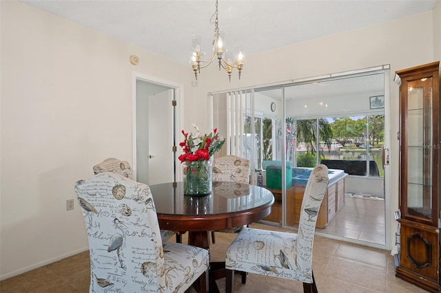 tiled dining area featuring a notable chandelier