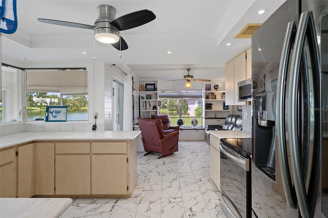 kitchen with ceiling fan, light brown cabinetry, appliances with stainless steel finishes, and a wealth of natural light