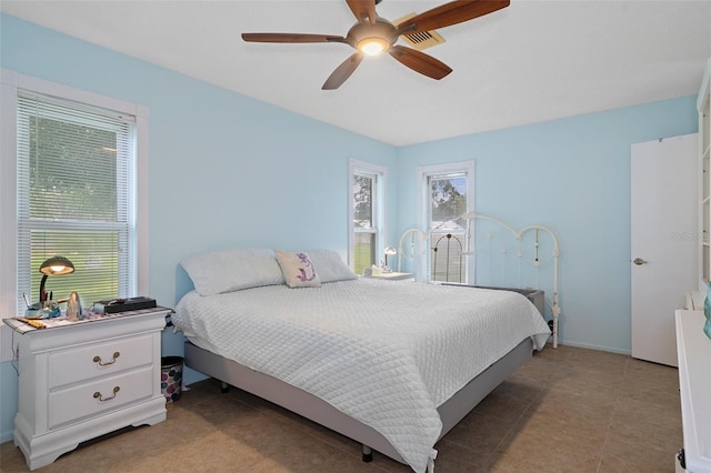 bedroom with ceiling fan and light tile patterned floors