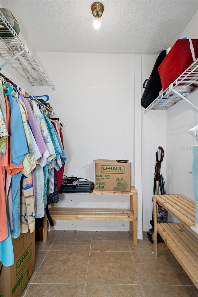 spacious closet with tile patterned floors