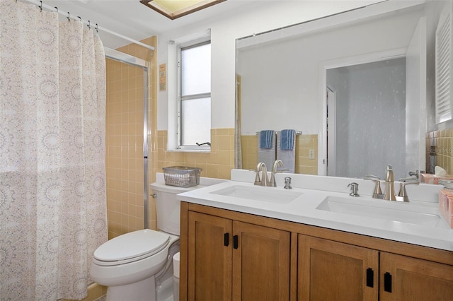 bathroom with walk in shower, tile walls, vanity, and toilet