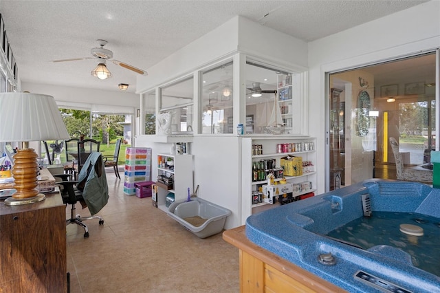 tiled office with ceiling fan and a textured ceiling