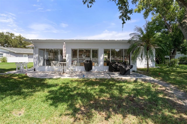 rear view of house with a yard and a patio