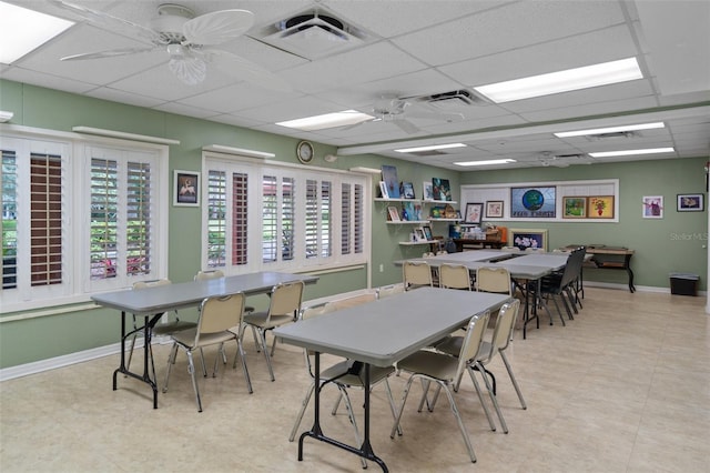 interior space featuring a paneled ceiling, ceiling fan, and plenty of natural light