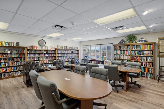 office area with light hardwood / wood-style flooring and a paneled ceiling