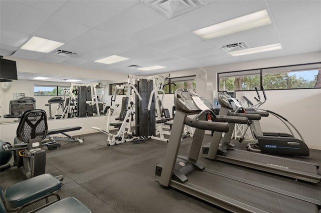 exercise room with a drop ceiling