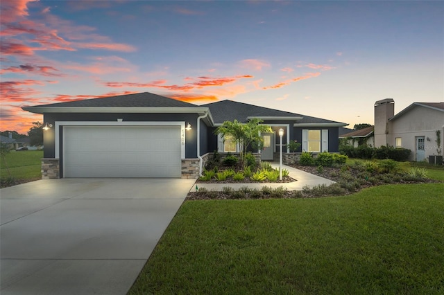 view of front of home with a lawn and a garage