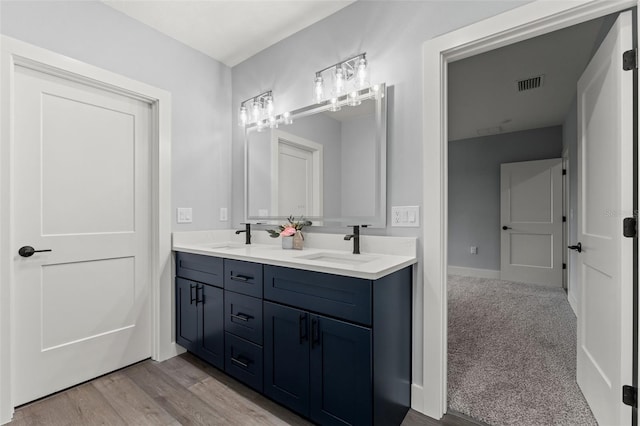 bathroom with vanity and hardwood / wood-style flooring